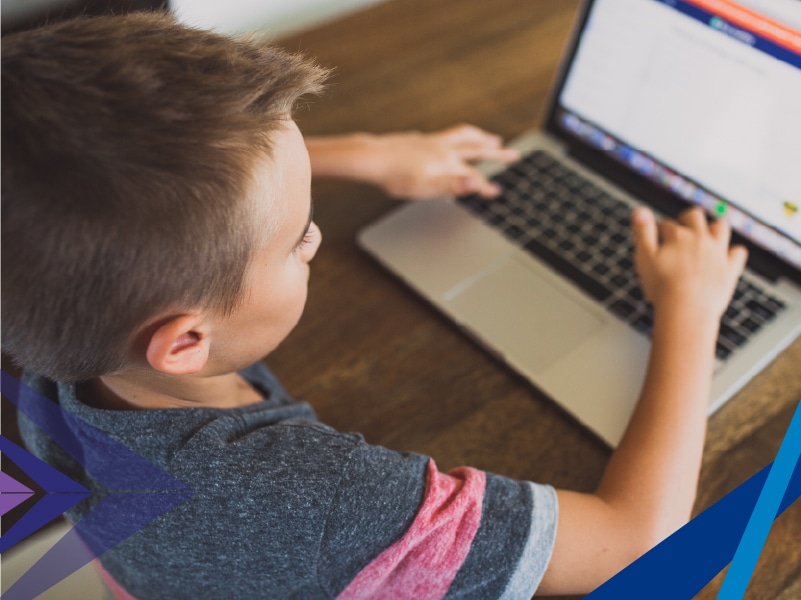 A kid navigating a laptop